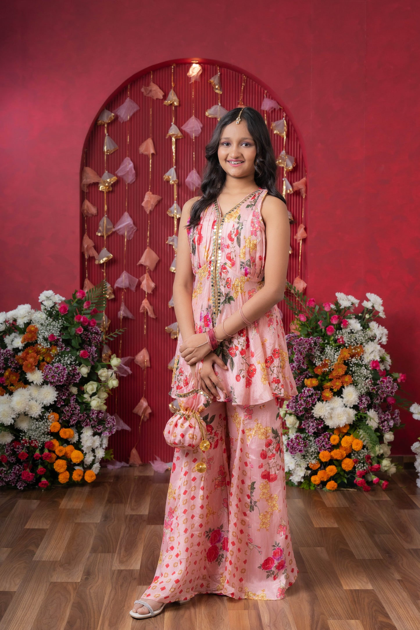 Floral Elegance: A chic peplum set with matching potli for festive charm