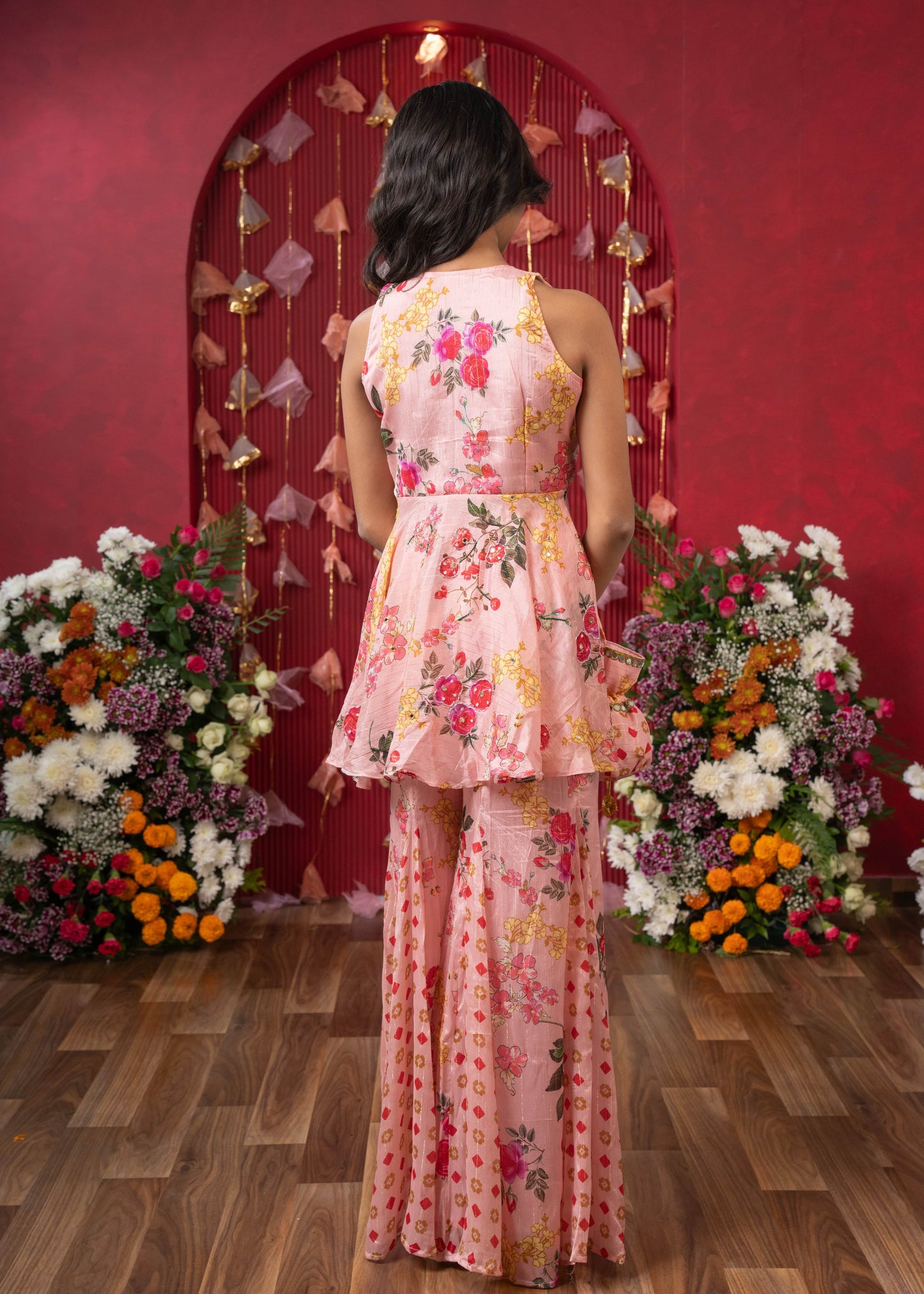 Floral Elegance: A chic peplum set with matching potli for festive charm